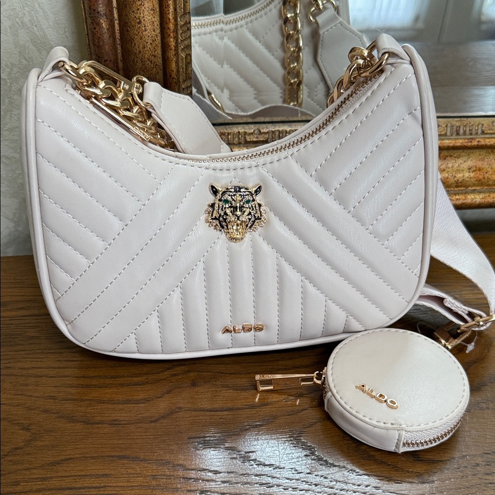 ALDO cream Quilted Kittaniix crossbody Bag with Gold Accents w/Lion decoration.